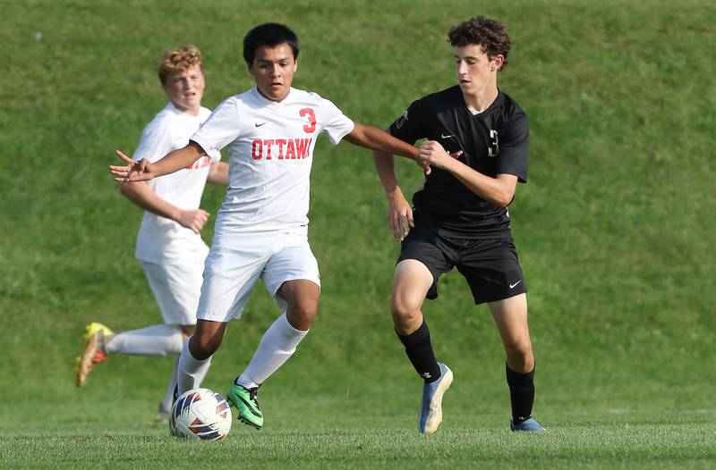 Ottawa's Christian Solis tries to hold off Sycamore's Nick Doering during their game Wednesday, Sept. 14, 2022, at Sycamore High School.