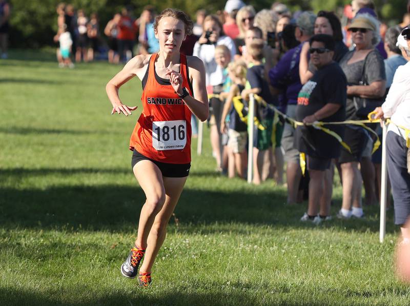 Sandwich's Sundara Weber finishes first in the girls race Tuesday, Aug. 30, 2022, during the Sycamore Cross Country Invitational at Kishwaukee College in Malta.