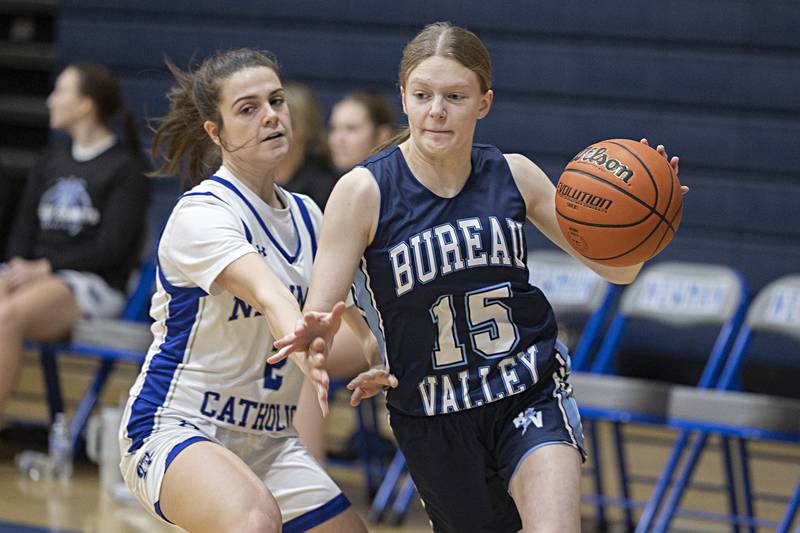 Bureau Valley’s Taylor Neuhalfen drives past Newman’s Helen Papoccia Thursday, Nov. 30, 2023 in Sterling.