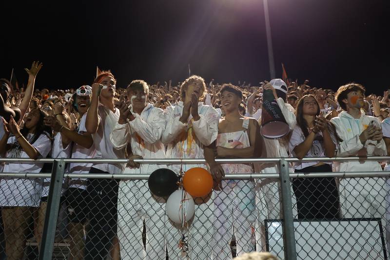 Lincoln-Way West fans cheer after the National Anthem bonfire the game against Bolingbrook on Friday, Sept. 22 in New Lenox.