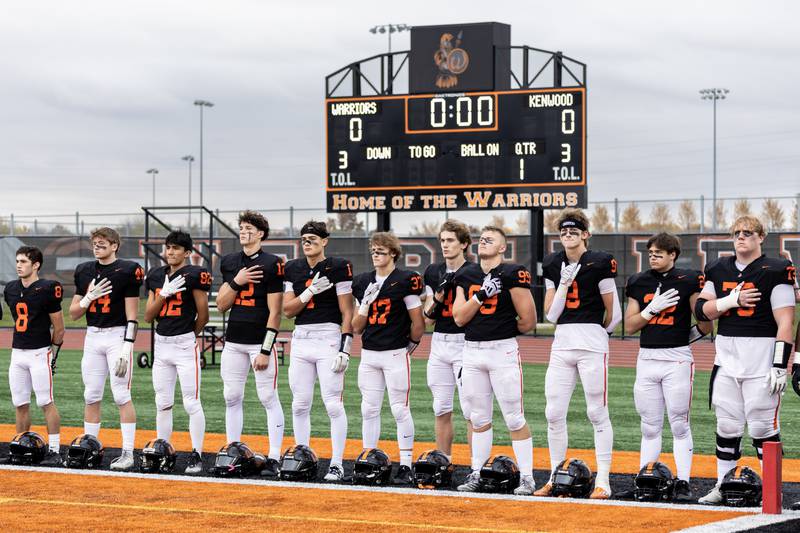 Lincoln-Way West’s players stand for the National Anthem prior to a 7A varsity football playoff game against Kenwood at Lincoln-Way West on Nov. 8, 2025.