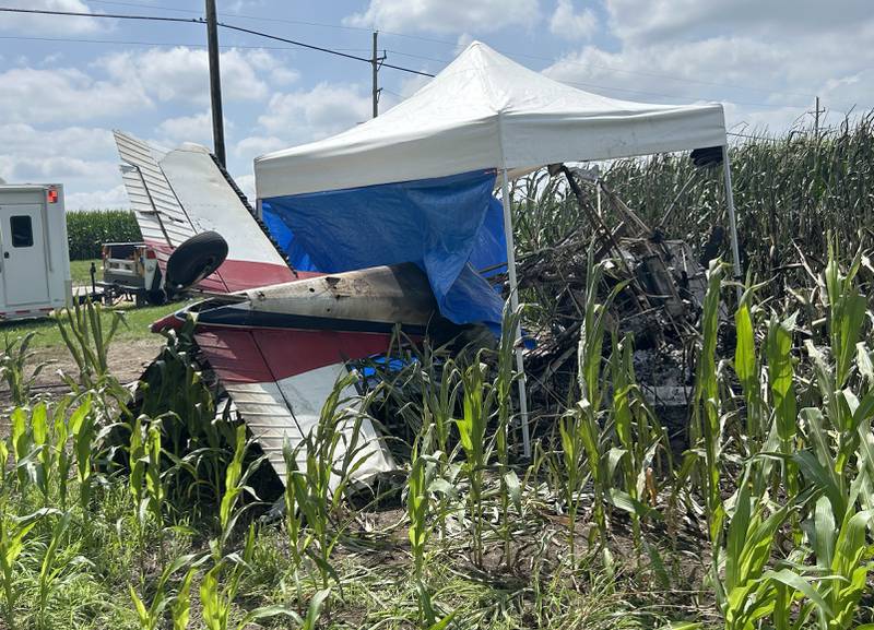 A crop dusting plane lies upside down in the edge of a cornfield along Illinois Route 64 near the Ogle County Airport between Oregon and Mt. Morris on Tuesday, July 22, 2025. The pilot of the plane was killed after hitting power lines near the airport. A section of Illinois Route 64 remained closed between Rock and Ridge roads as ComEd crews worked to repair damage to poles and lines. This photo was taken after the pilot was removed from the wreckage.