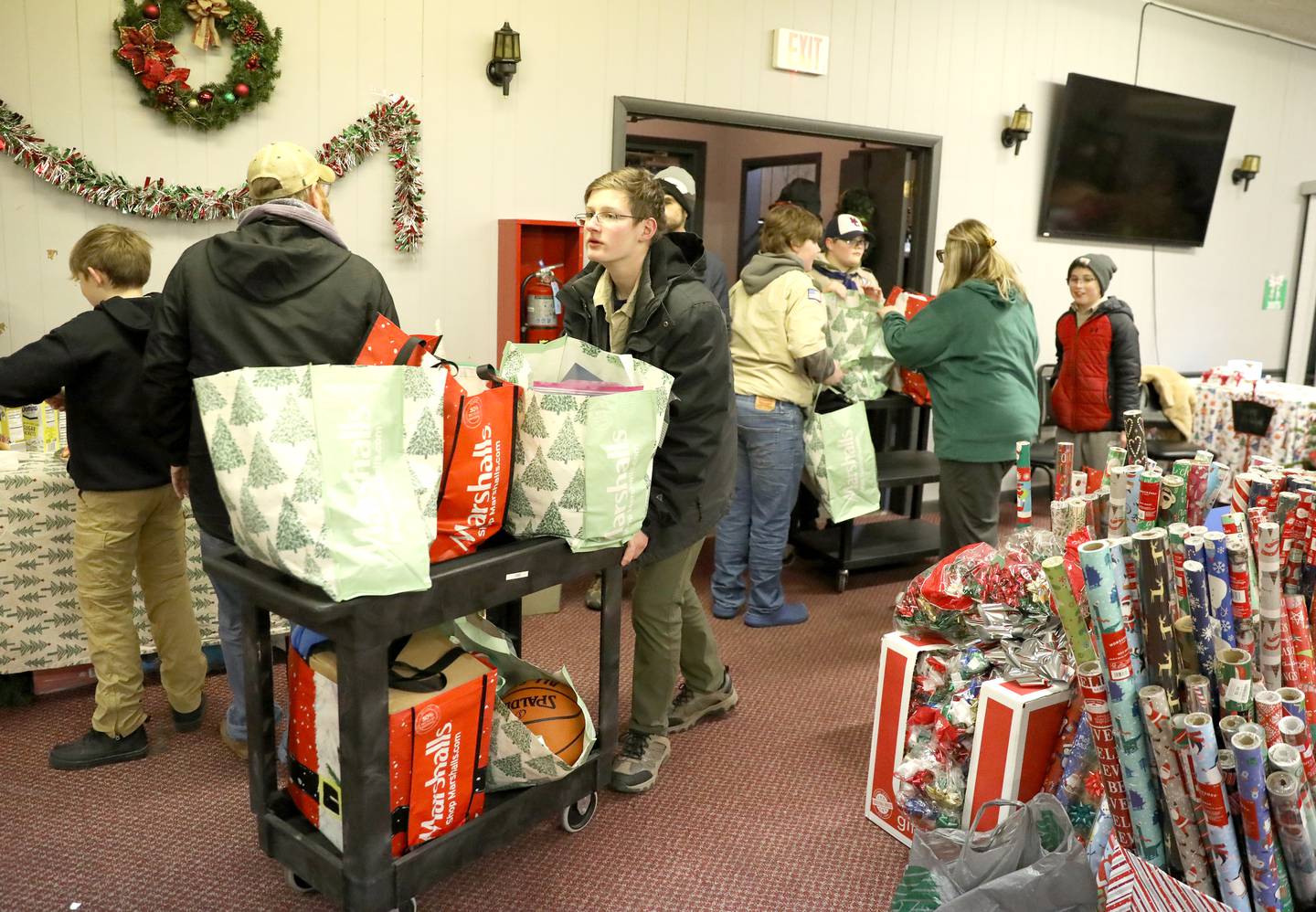 Ben Arends, 13, of Boy Scout Troop 21 helps unload donated gifts and essentials as part of the Batavia United Way Adopt-A-Family program.