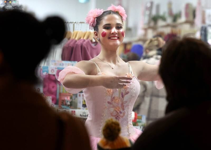 Veronica Young, 15, from Genoa, along with others from the Beth Fowler School of Dance perform in the window of Adventure Sprouts for visitors Friday, Nov. 22, 2024, during Moonlight Magic in downtown Sycamore.