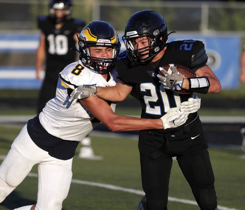 Highland Park's Nicholas Rosenbloom (20) tires to push past Leyden's Mario Reyes (8)   Friday August 26, 2022 in Highland Park.