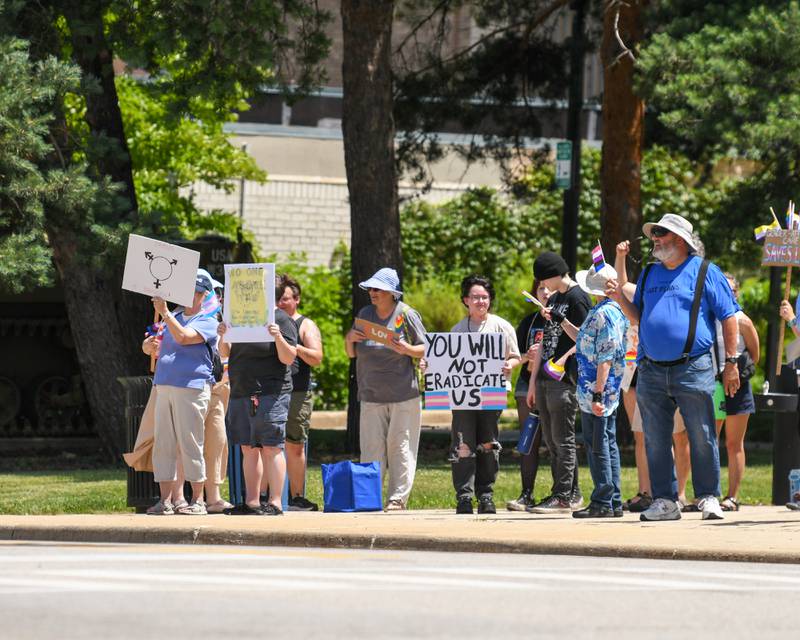 Community members hold signs in support of transgender rights during a Trans Resilience Rally held on Sunday, June 22, 2025, in downtown DeKalb. Organizers said the rally was to show public support for people they believe are unjustly and harmfully targeted under President Donald Trump's policies.