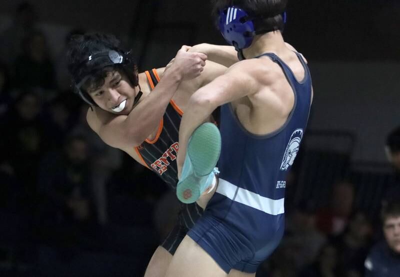 Crystal Lake Central’s Abe Pabmino, left, battles Cary-Grove’s Jacob Turner at 138 pounds in varsity wrestling Thursday, Dec. 19, 2024 at Cary-Grove High School in Cary.