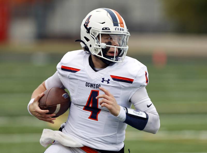 Oswego's Drew Kleinhans (4) runs with the ball during the varsity football second-round 8A playoff game between Oswego and Lane Tech on Saturday, Nov. 8, 2025 in Chicago.
