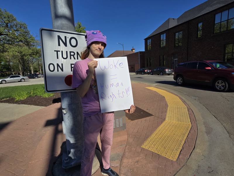 Residents hold signs Tuesday, May 6, during a peace rally at Streator's City Park. The intent of the rally is to come together to stop recent violence in the city.
