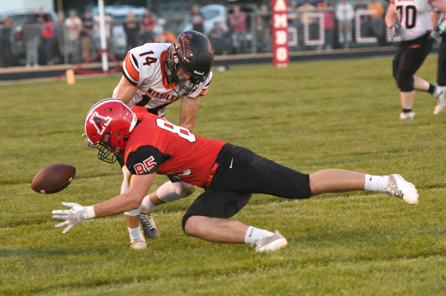 Amboy's Brennan Blaine dives for the ball as Milledgeville's Kacen Johnson tries to break up the pass on Friday. Sept. 9.