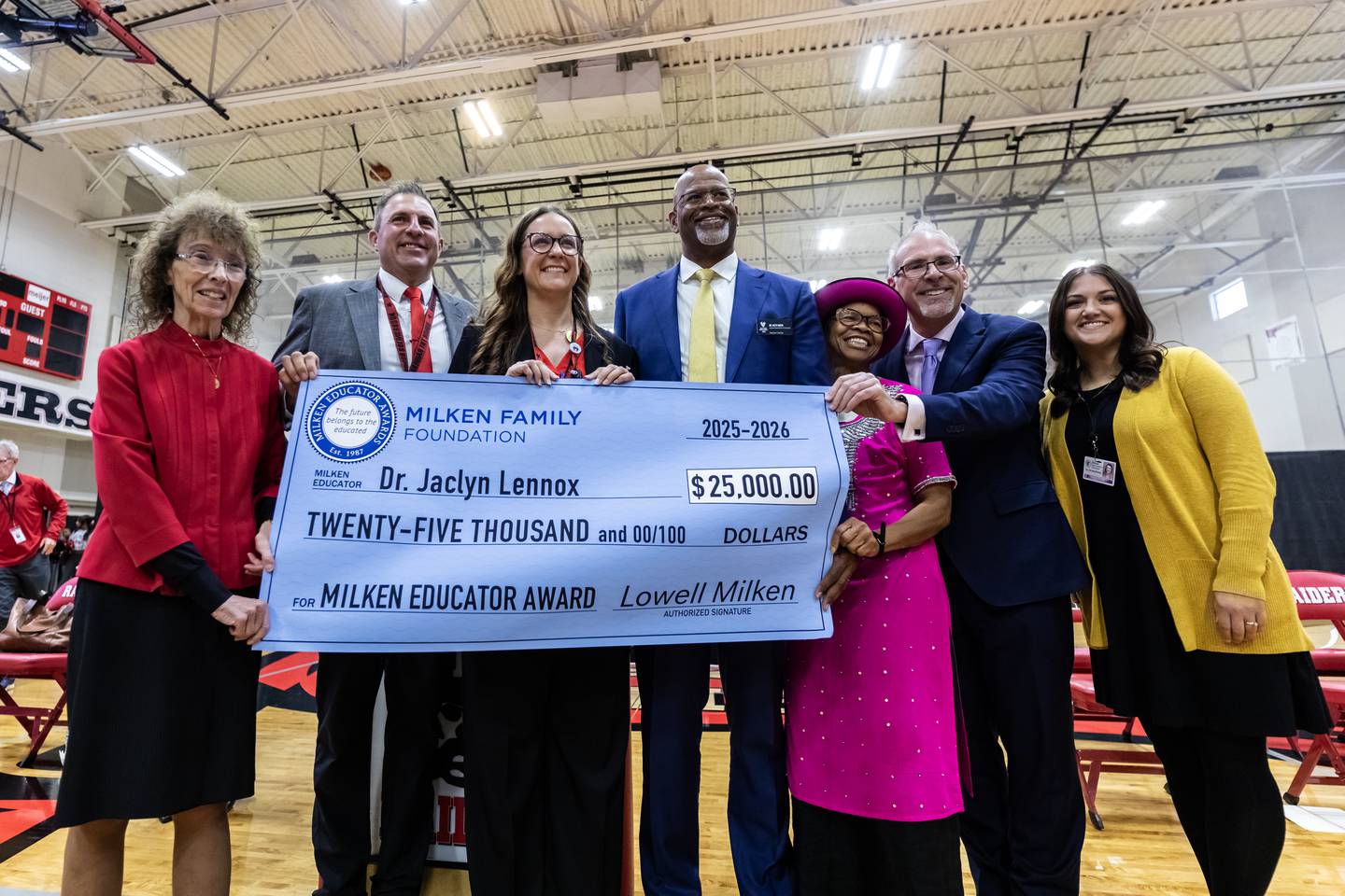 Dr. Jaclyn Lennox, Bolingbrook High School’s assistant principal of curriculum and instruction, poses for a photo with school an state administrators and Milken Educator Awards representatives after winning the Milken Educator Award during a surprise assembly at Bolingbrook High School on Oct. 16, 2025.