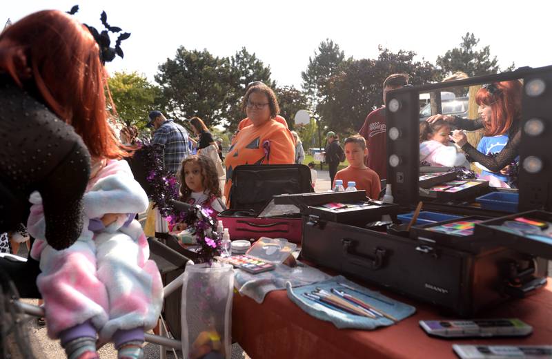 Lucia Gibfried of Countryside gets her face painted by Maria Artemova of LaGrange on Saturday, Oct. 12, 2024 during a Trunk or Treat event at Sedgwick Park in La Grange.