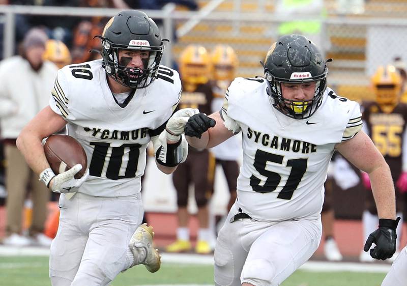Sycamore's Zack Crawford follows the blocking of Gable Carrick during their Class 5A second round playoff game against Carmel Saturday, Nov. 5, 2022, at Carmel Catholic High School in Mundelein.