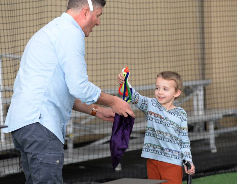 Oliver Muheim of Glen Ellyn is Todd Jabaay's magical assistant during the Glen Ellyn Park District's Hoppy party Saturday, March 30, 2024.