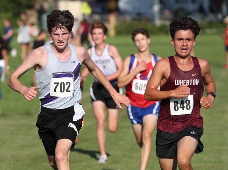 Rochelle’s Declan McGee (left) finishes strong in the varsity race Tuesday, Sept. 2, 2025, during the Sycamore Cross Country Invitational at Northern Illinois University in DeKalb.
