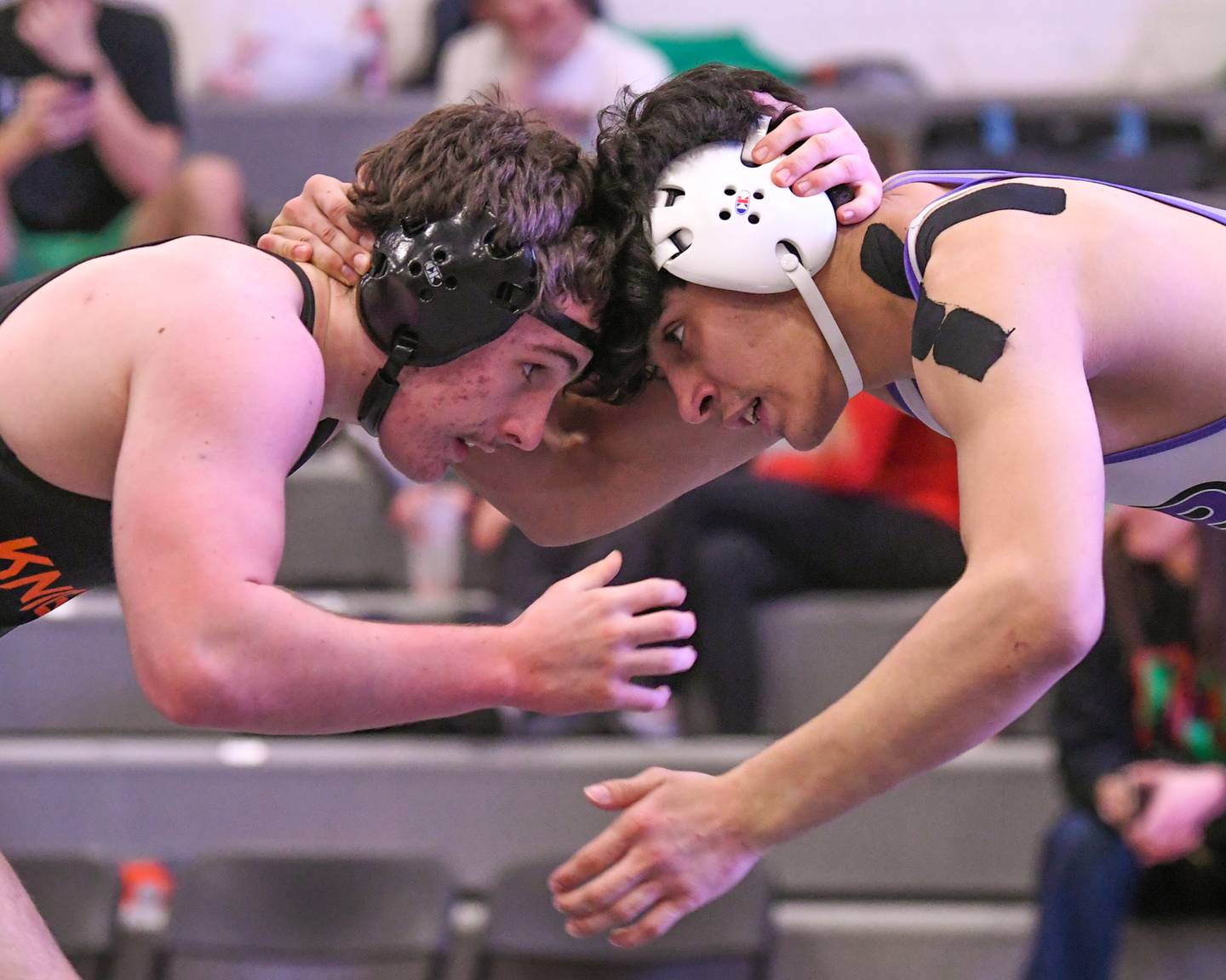 Apollo Gochis, left of Kaneland goes head-to-head with Luis Ballesteros of Plano during the regional championship match in the 175-weight class where Luis took the win on Saturday Feb. 8, 2025, held at Kaneland High School.
