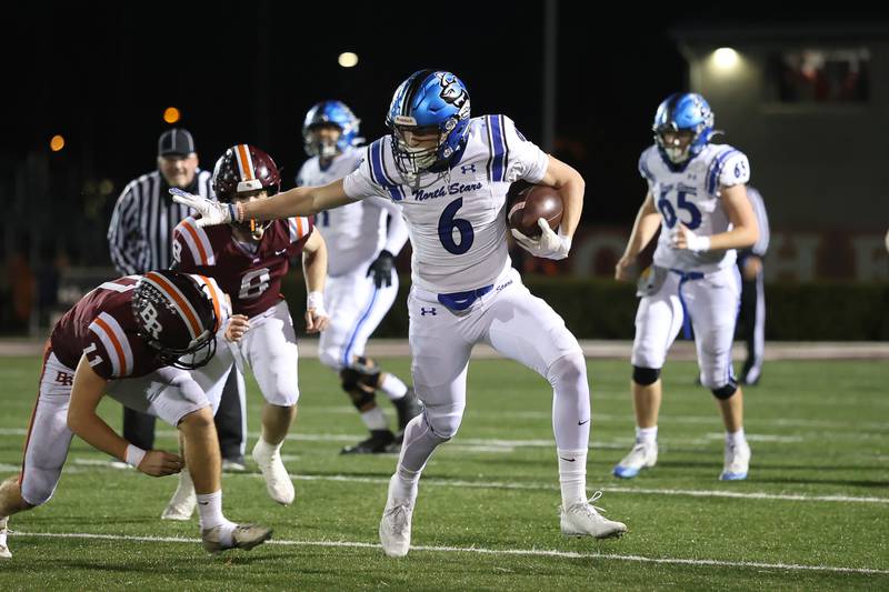 St. Charles North's Keaton Reinke stiff arms a Brother Rice defender on a catch and run in the third round of the playoffs on Saturday, Nov. 15, 2025 in Chicago.