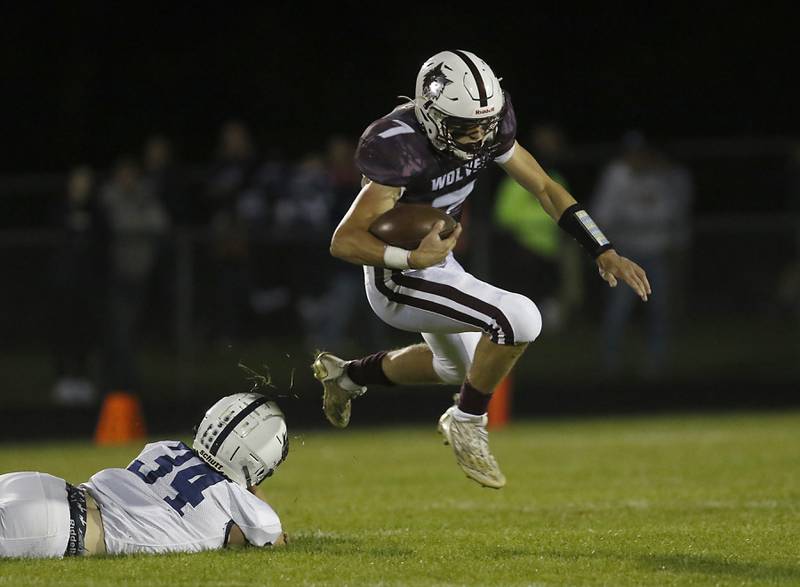 Prairie Ridge's Tyler Vasey leaps over the tackle attempt of Cary-Grove's Jack Rocen during a Fox Valley Conference football game between Prairie Ridge  and Cary-Grove Friday, Sept. 23, 2022, at Prairie Ridge High School in Crystal Lake.