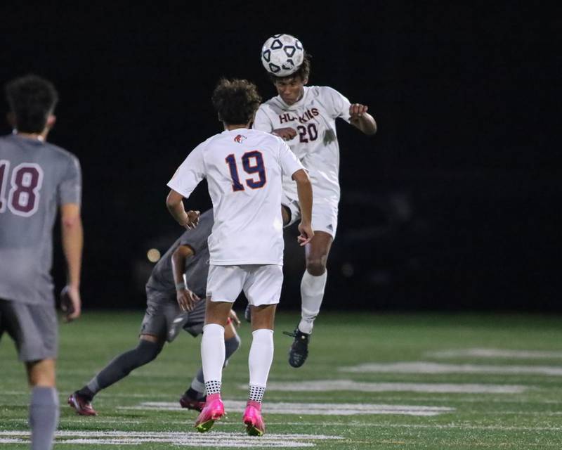 Naperville North's Andrew Hebron (20) heads the ball during soccer match between Naperville North at Morton.  Sept 21, 2023.