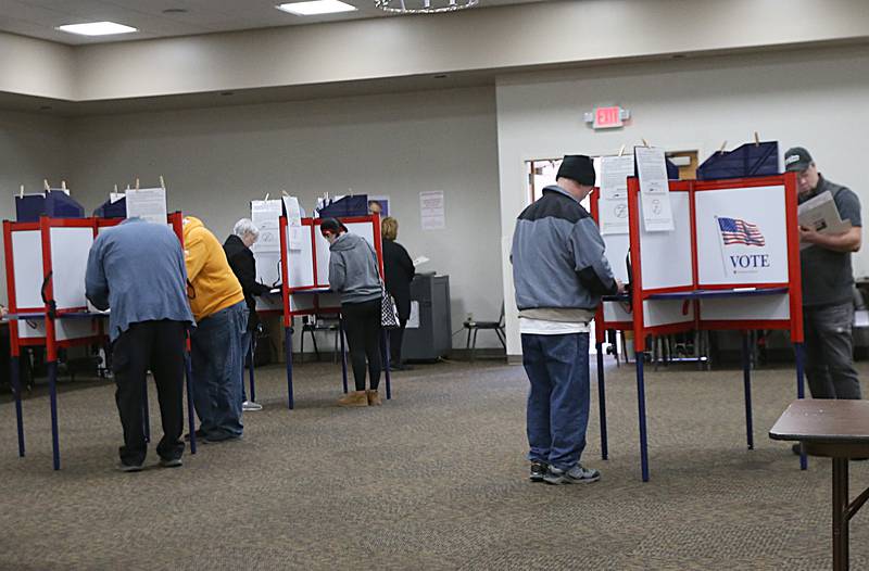 Voters fill their ballots out at the Knights of Columbus Hall on Tuesday, Nov. 8, 2022 in Ottawa.