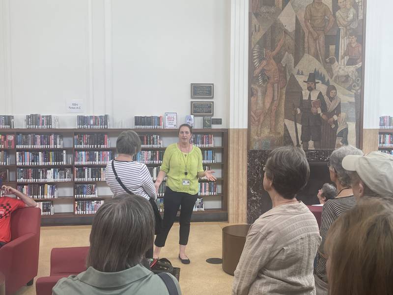 DeKalb Public Library executive director Emily Faulkner (center) leads a tour July 6, 2024 at the DeKalb Public Library during a program held in collaboration with the J.F. Glidden Homestead and Historical Center.