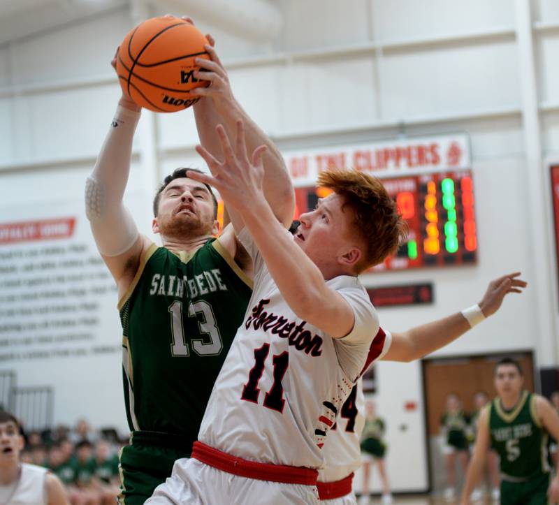 Forreston's Connor Politsch (11) and Peru St. Bede's Mason Ross (13) battle for a rebound during Wednesday, Feb. 26, 2025 action at the 1A Amboy Regional at Amboy High School. The Cardinals won the game  67-56 to advance to the regional championship game on Friday against Annawan.