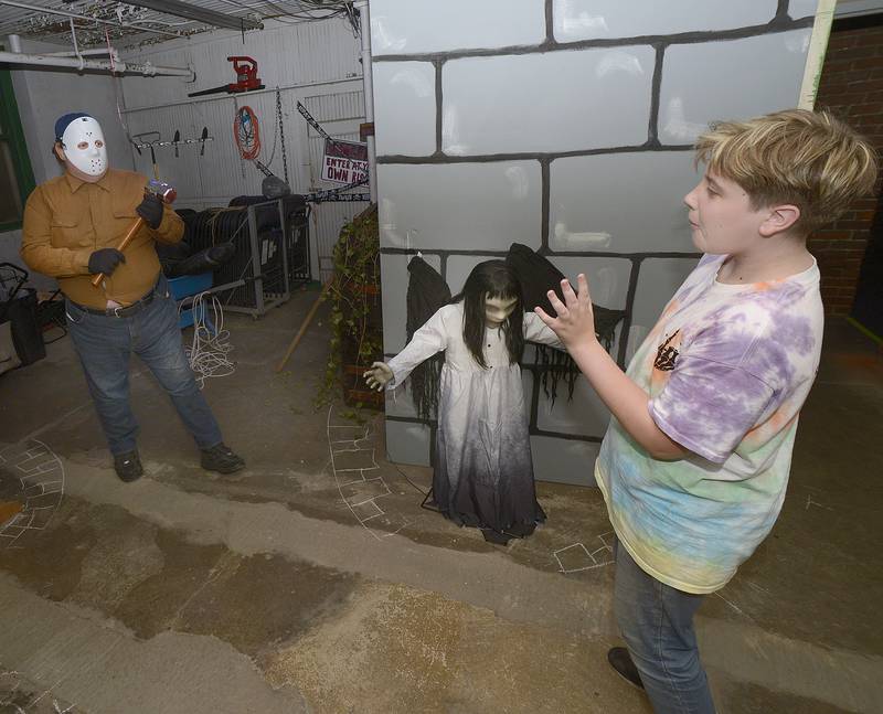 Dominic Melvin interacts with a frightening charachter at the Streator Library’s Haunted House during the Streator Chamber sponsored Halloween Spooktacular scavenger hunt Friday night.