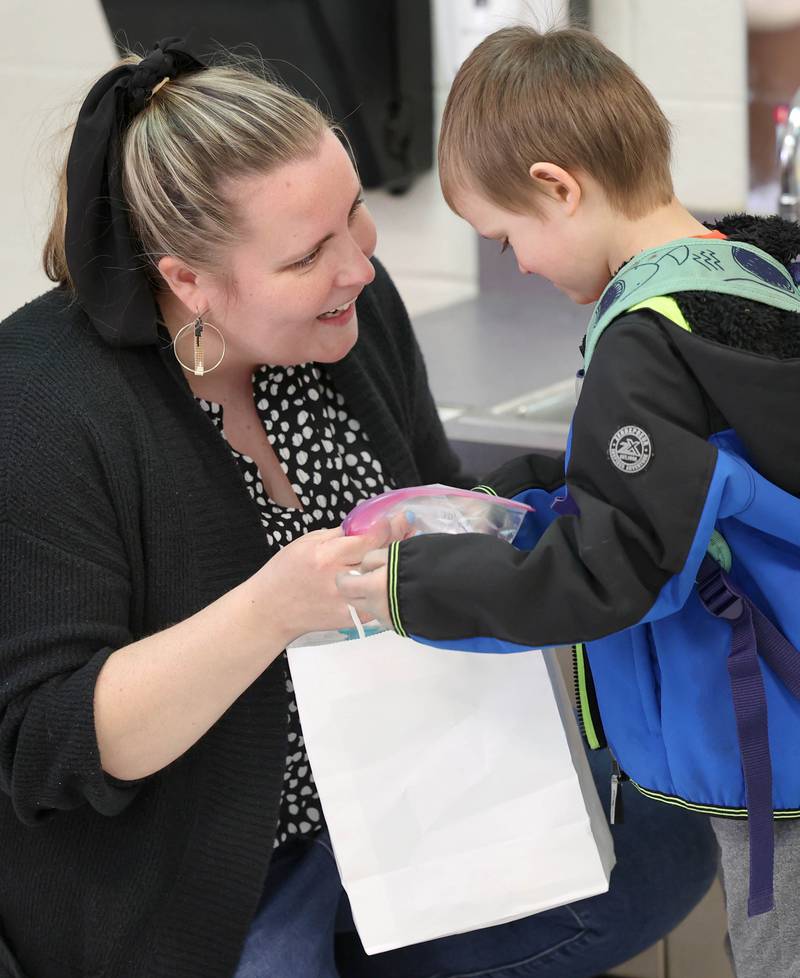 Laurel Copeland, Little Spartans Early Learning Program teacher at South Prairie Elementary School, greets Henry Landis as he arrives Wednesday, April 6, 2023, at the school in Sycamore.
