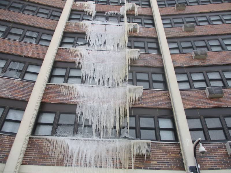 Icicles formed along several stories of a section of the John F. Kennedy Terrace building in Joliet after a heating pipe burst. Dec. 27, 2022.