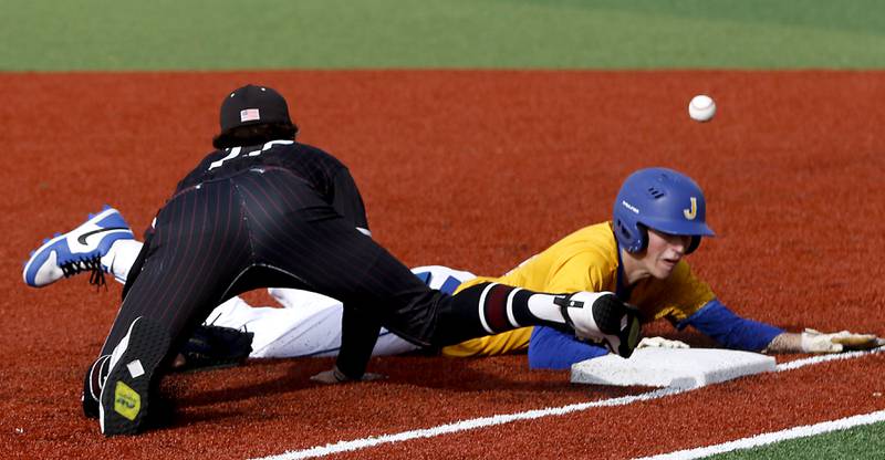 The ball bounces away from Marengo's Brady Kentgen as Johnsburg's Ahston Stern dives back during a Kishwaukee River Conference baseball game against on Monday, April 21, 2025, at Johnsburg High School. Stern advanced to third on the play.