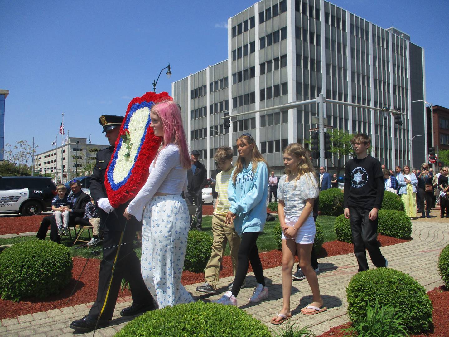 The great-grandchildren of Louis Barney, a Joliet police officer who died in 1954, present a wreath at the Law Enforcement Memorial Day ceremony on Thursday. May 8, 2025