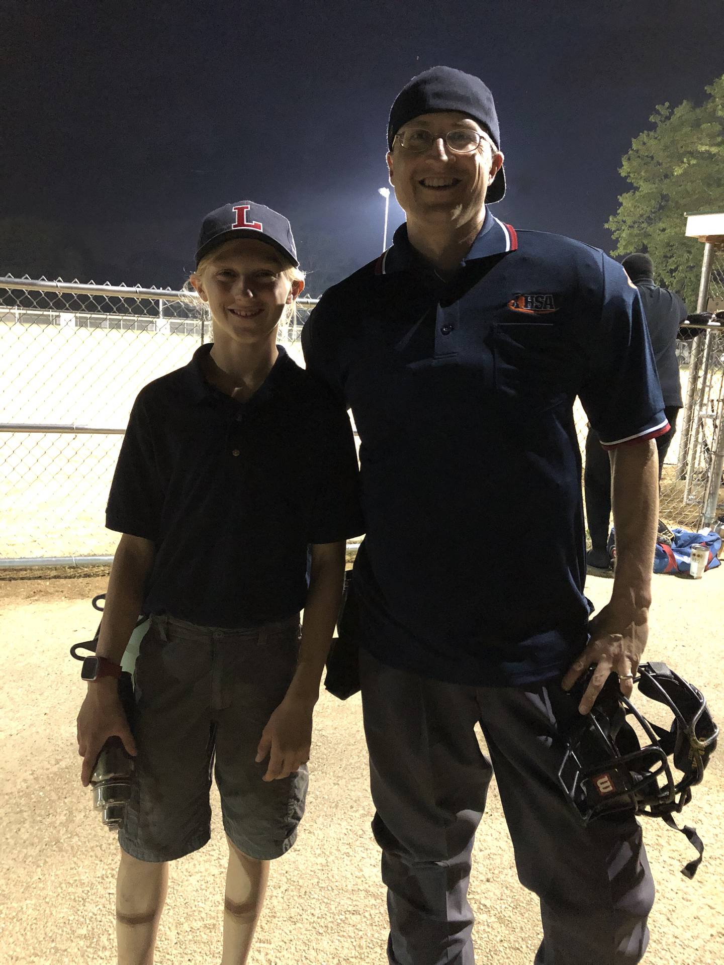 Scott T. Holland and his son Max, 15, prepare to team up as umpires for a ball game.