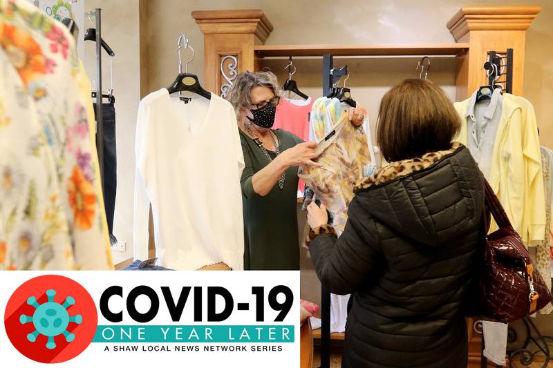 The Clothes Gallery employees Lori Galloway of McHenry, left, help customer Andi Bernstein of South Barrington pick out some new clothes in the store on St. Patrick's Day, Wednesday, March 17, 2021 in Crystal Lake. "I have an hour and half free and I chose to come here," Bernstein told Galloway upon entering the store.