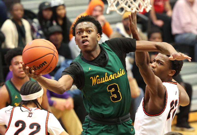 Waubonsie Valley's Tre Blissett gets to the basket in front of DeKalb’s Justin O’Neal during their game Friday, Dec. 15, 2023, at DeKalb High School.