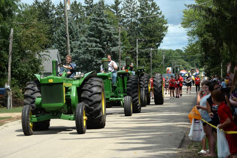Members of the Miller family drive their John Deere tractors in the German Valley Days parade on Saturday, July 19, 2025.