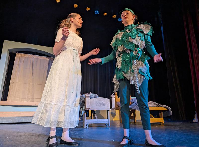 Wendy Darling, played by Liv Schauff, and Peter Pan, played by Kate Wadsworth, interact on stage in the James A. Wiltz Auditorium at Dixon High School during Woodlawn Arts Academy and Dixon Public Schools’ winter musical theater production of “Peter Pan Jr.”
