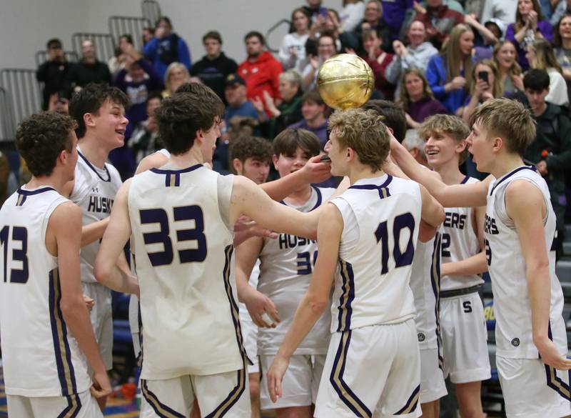 Members of the Serena boys basketball team hoist the Little Ten Conference Championship trophy after defeating Earlville on Friday, Feb. 2, 2024 at Somonauk High School.