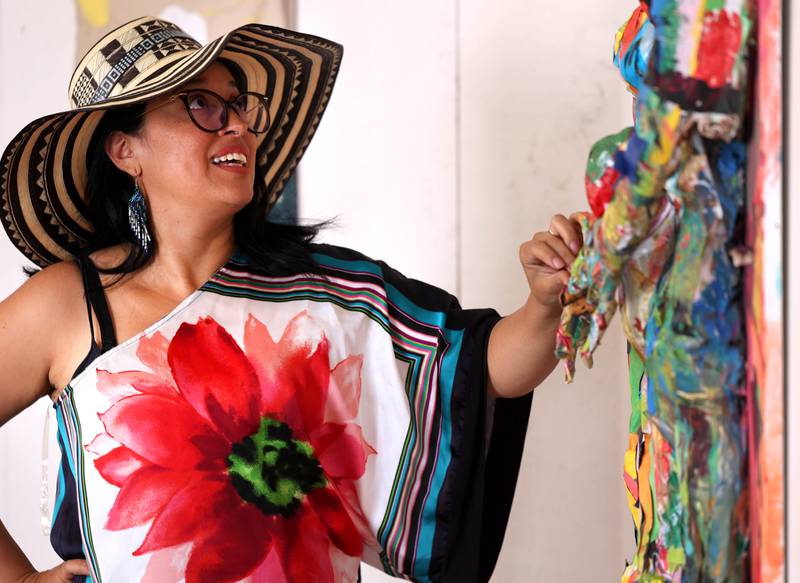DeKalb resident Carolina Velandia talks about her work entitled “Dance, Love, and Art” Wednesday, Sept. 18, 2024, that is part of the Arts in Action exhibition at the Ellwood House Museum in DeKalb. The exhibit features work by local Latino artists and runs through the end of the year.