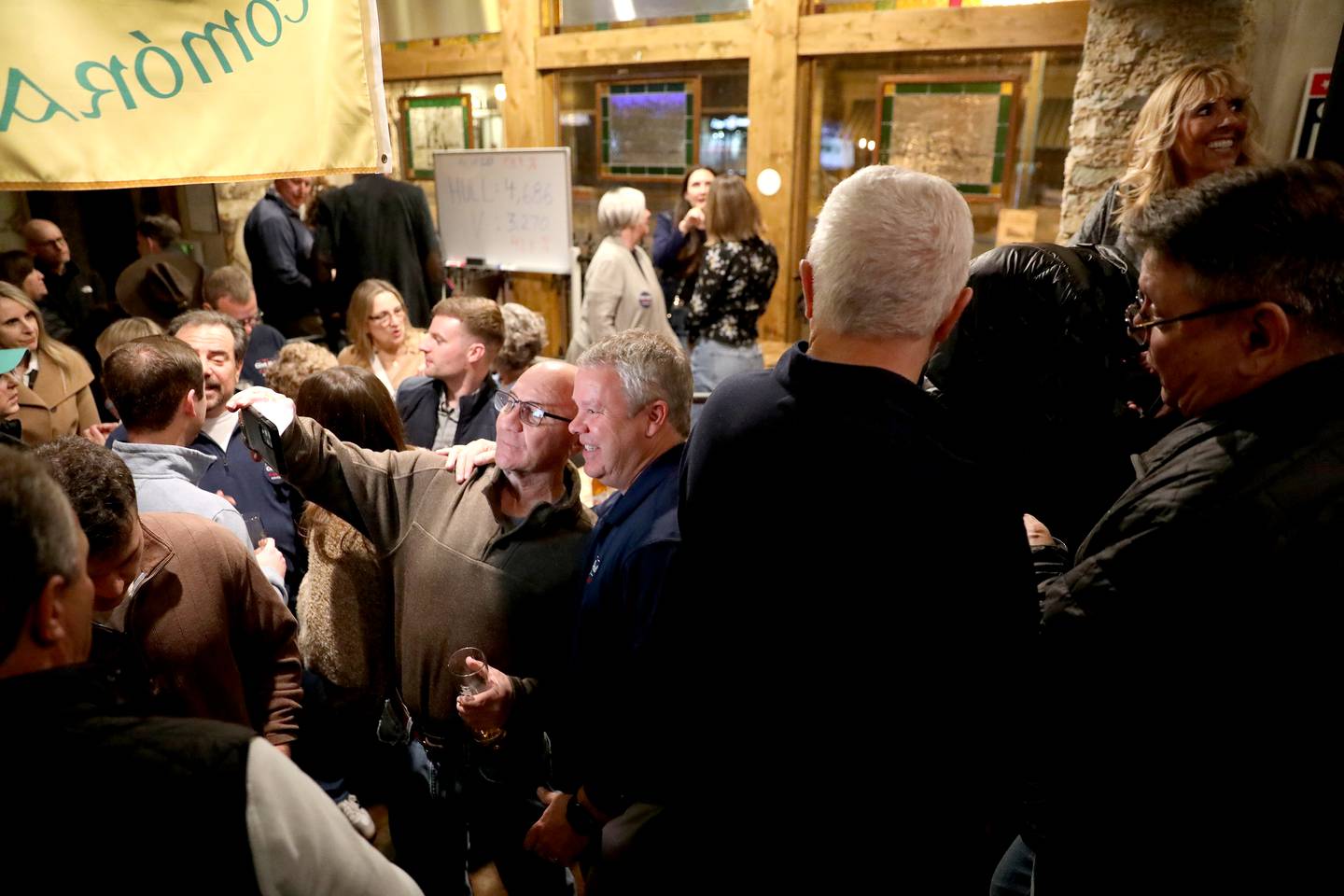 Clint Hull (right), candidate for St. Charles Mayor, visits with supporters while awaiting election results at McNally’s Irish Pub on Tuesday, April 1, 2025 in St. Charles.
