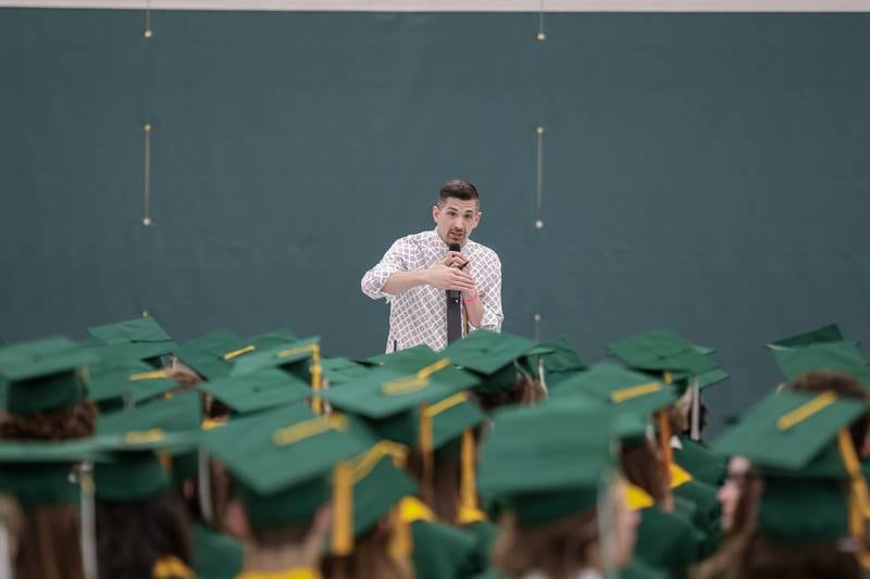 Assistant Principal Chris Mitchell gives instructions before the Glenbard West High School graduation ceremony. May 19, 2022