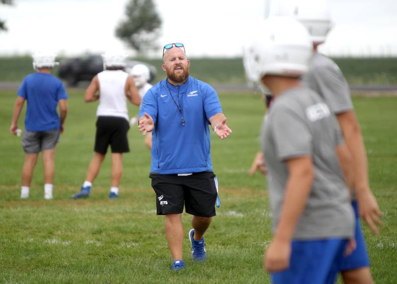 Burlington Central Head Coach Brian Iossi leads his team during the first official practice of the season on Monday, Aug. 8, 2022.