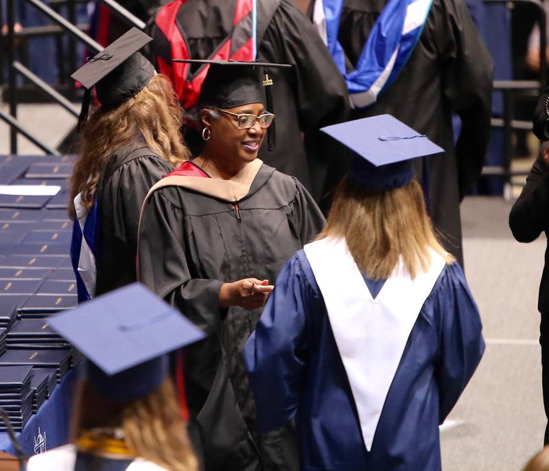 District 308 Board of Education President, Mrs. LaTonya Simelton gives Oswego High School seniors their diplomas on Saturday, May 21, 2022.