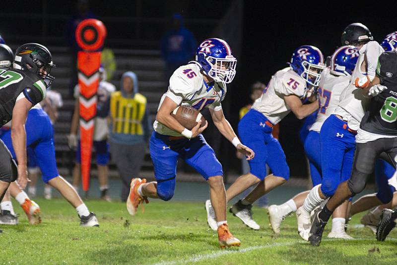 Genoa-Kingston’s Maddox Lavender runs through the hole Friday, Sept. 23, 2022 against Rock Falls.