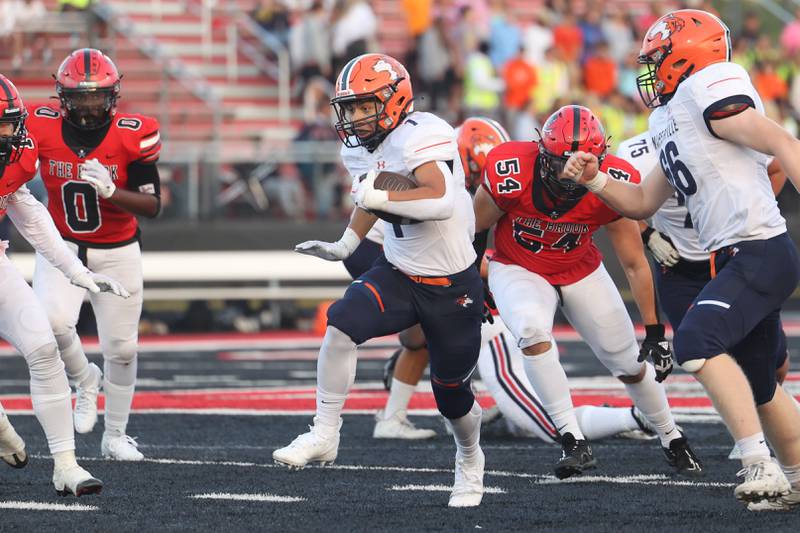 Naperville North’s Cole Arl breaks through the line on a run against Bolingbrook on Friday, Sept. 8, 2023 in Bolingbrook.