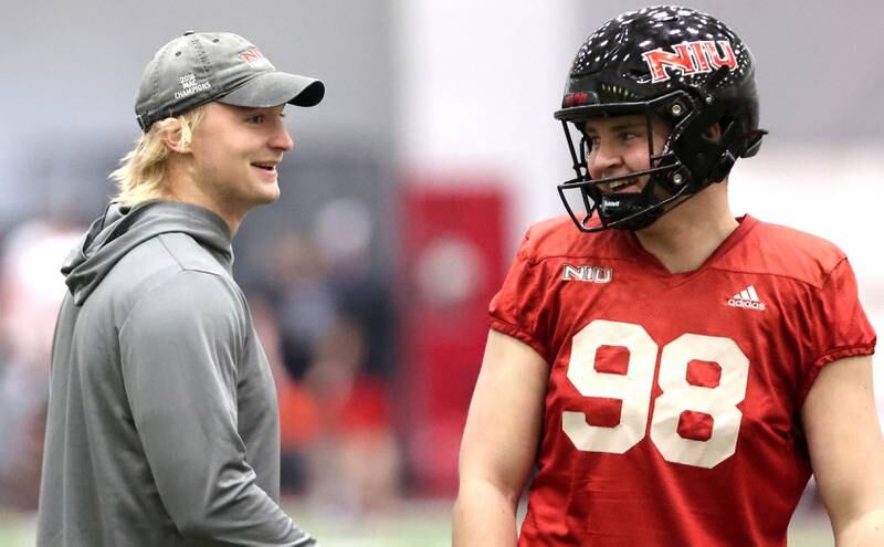 Northern Illinois quarterback Rocky Lombardi (left) talks to punter Tom Foley during the teams first spring practice Wednesday, March 22, 2023, in the Chessick Practice Center at Northern Illinois University in DeKalb.