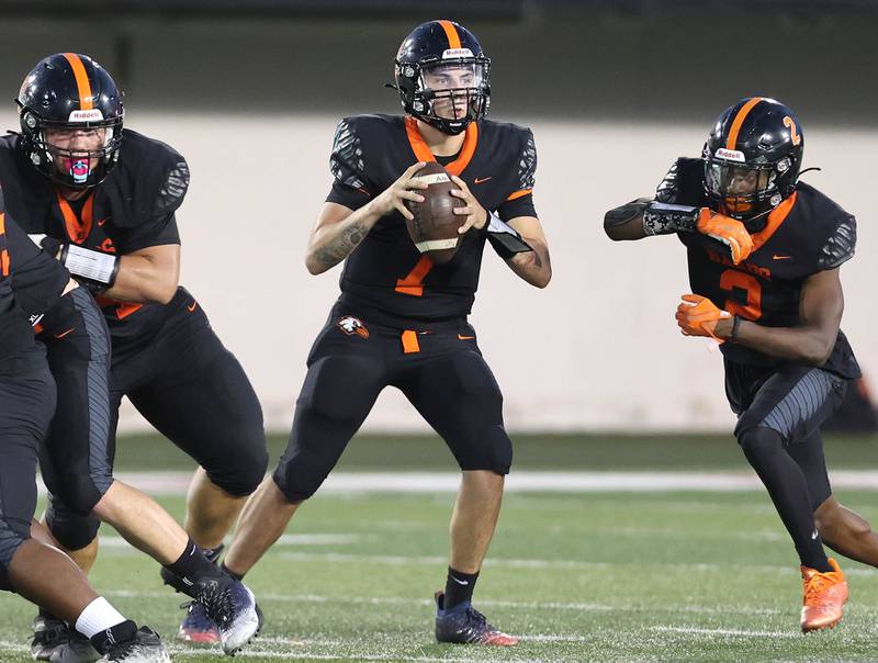 DeKalb's Adrien McVicar looks for a receiver during the First National Challenge against Sycamore Friday, Aug. 26, 2022, in Huskie Stadium at Northern Illinois University in DeKalb.