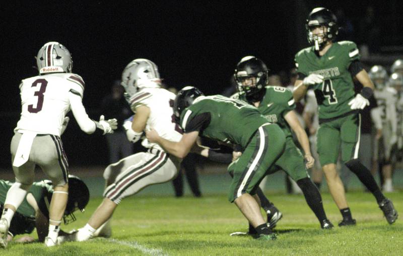IVC player Sawyer Ellenwood is wrapped up by Rocket defenders. The Grey Ghosts of Illinois Valley Central traveled to Hinders Field in Rock Falls on Friday, October 10, 2025 to take on the Rockets.