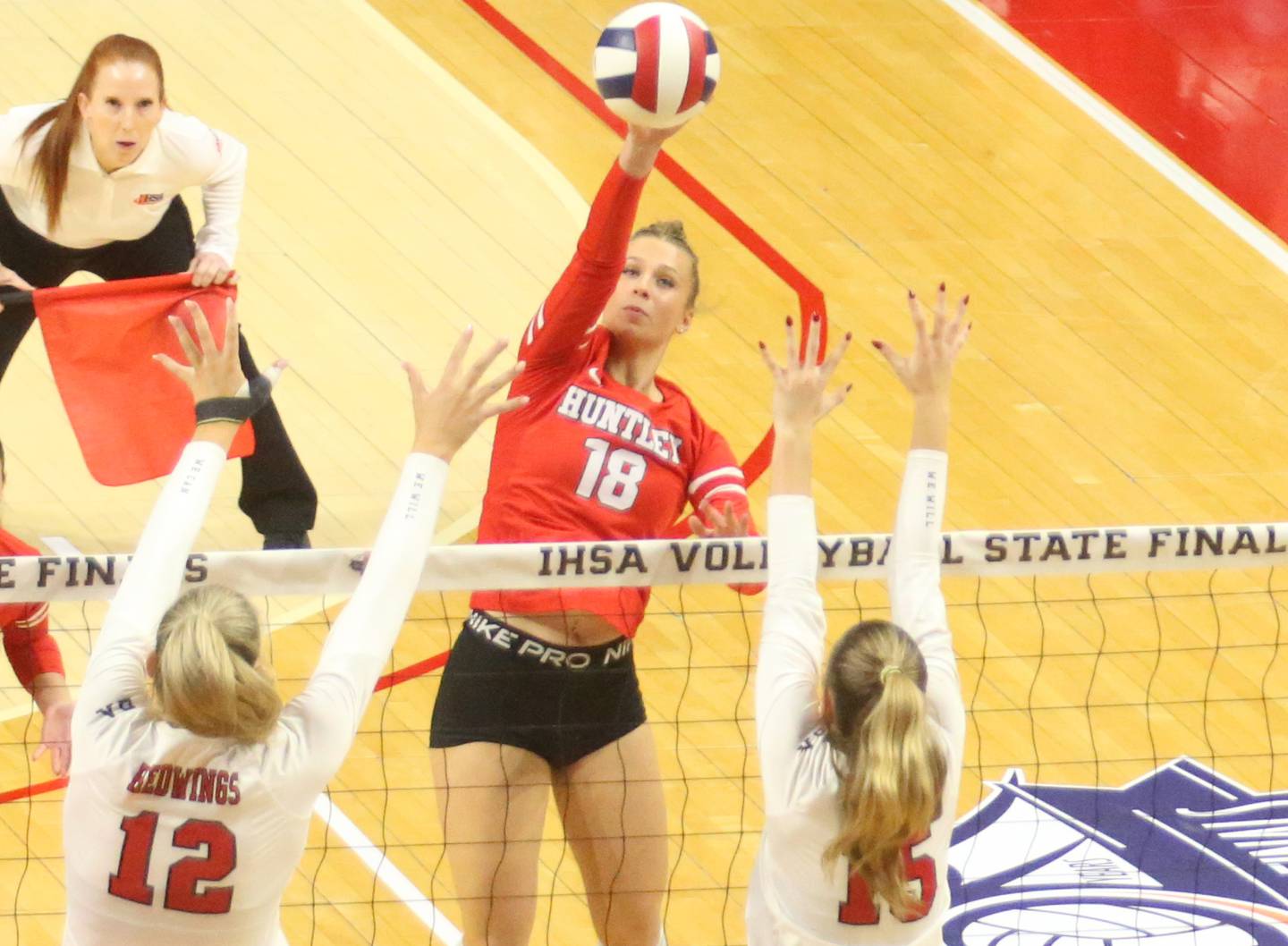 Huntley's Sienna Robertson slices a kill past Benet's Lynney Tarnow and teammate Sophia Chinetti during the Class 4A State semifinal game on Friday, Nov. 15, 2024 at CEFCU Arena in Normal.