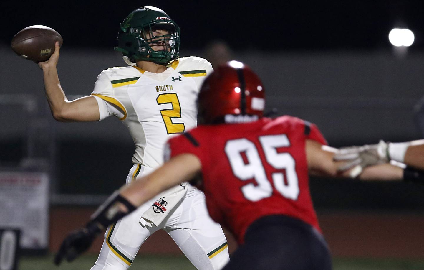 Crystal Lake South's Caden Casimino throws a pass as he is pressured by Huntley's Carter Pope during a Fox Valley Conference football game on Friday, Sept. 29, 2023, at Huntley High School.