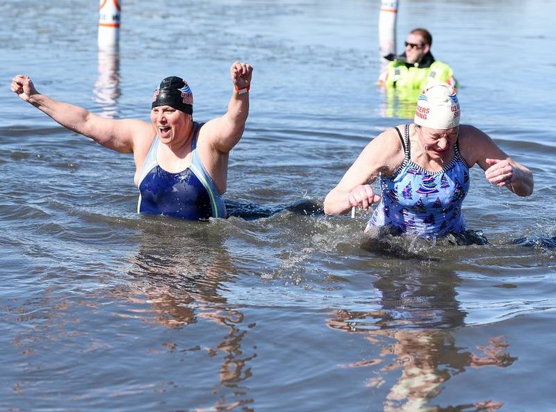 Tracy Sypura, left, and Michelle Ryan of Huntley take the plunge Sunday during the Fox Lake Polar Plunge for Special Olympics at Nippersink Lake.